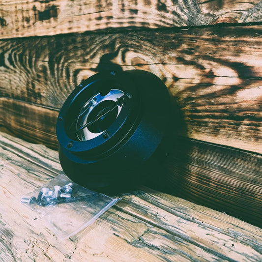  Black Aluminum Alloy steering wheel hub adapter with mounting hardware for vehicle installation