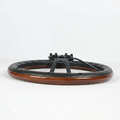 A circular black and wood table base or pedestal with a glossy brown wood-grain outer ring and a black metal central support structure, photographed on a clean white studio background.