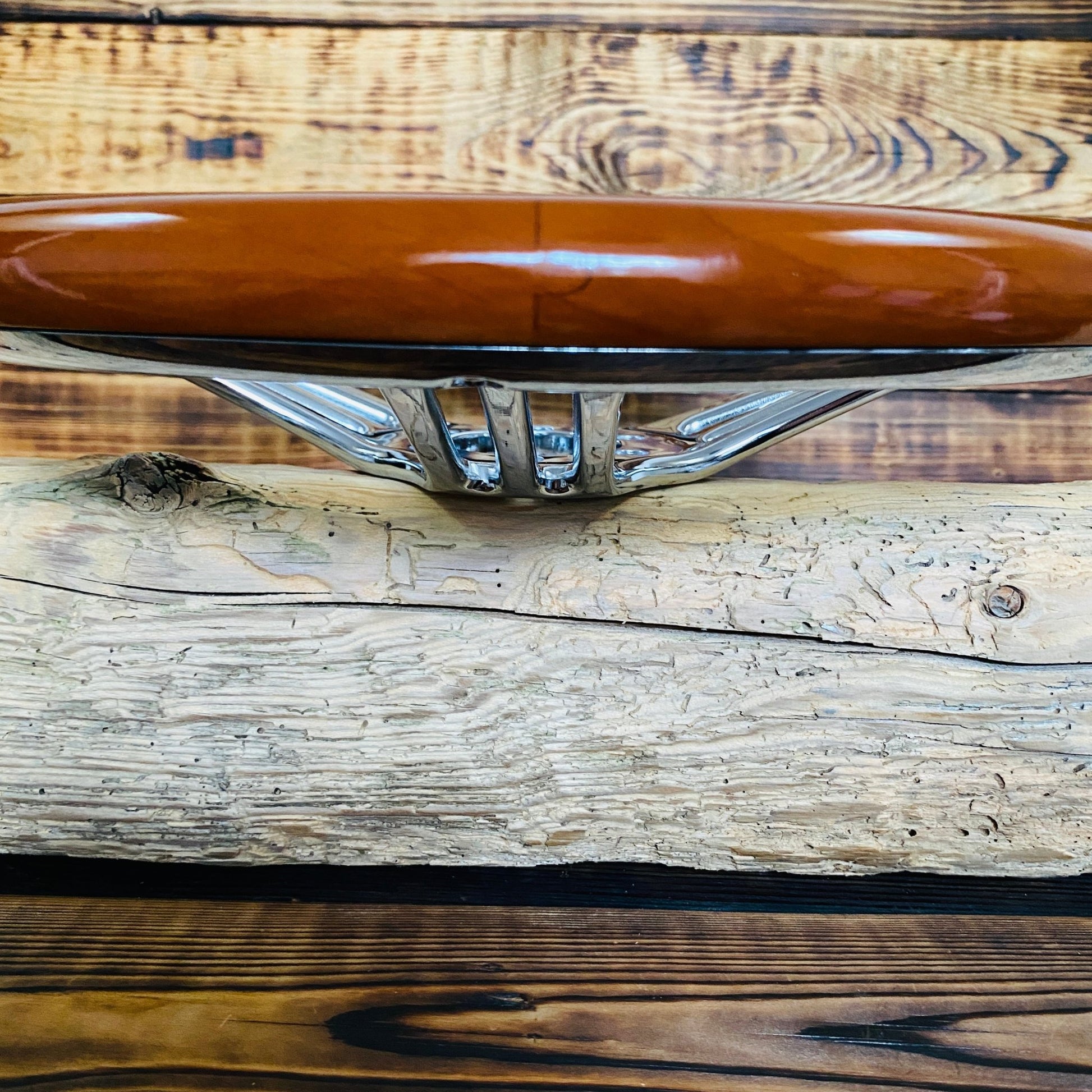 14 inch wood steering wheel with chrome spokes for BMW steering wheel, side view on wooden background