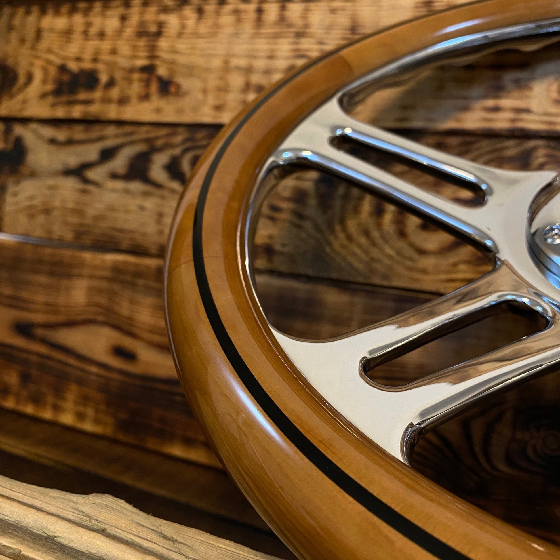 Close-up of 14 inch wood steering wheel bmw with polished metal spokes and brown wood rim
