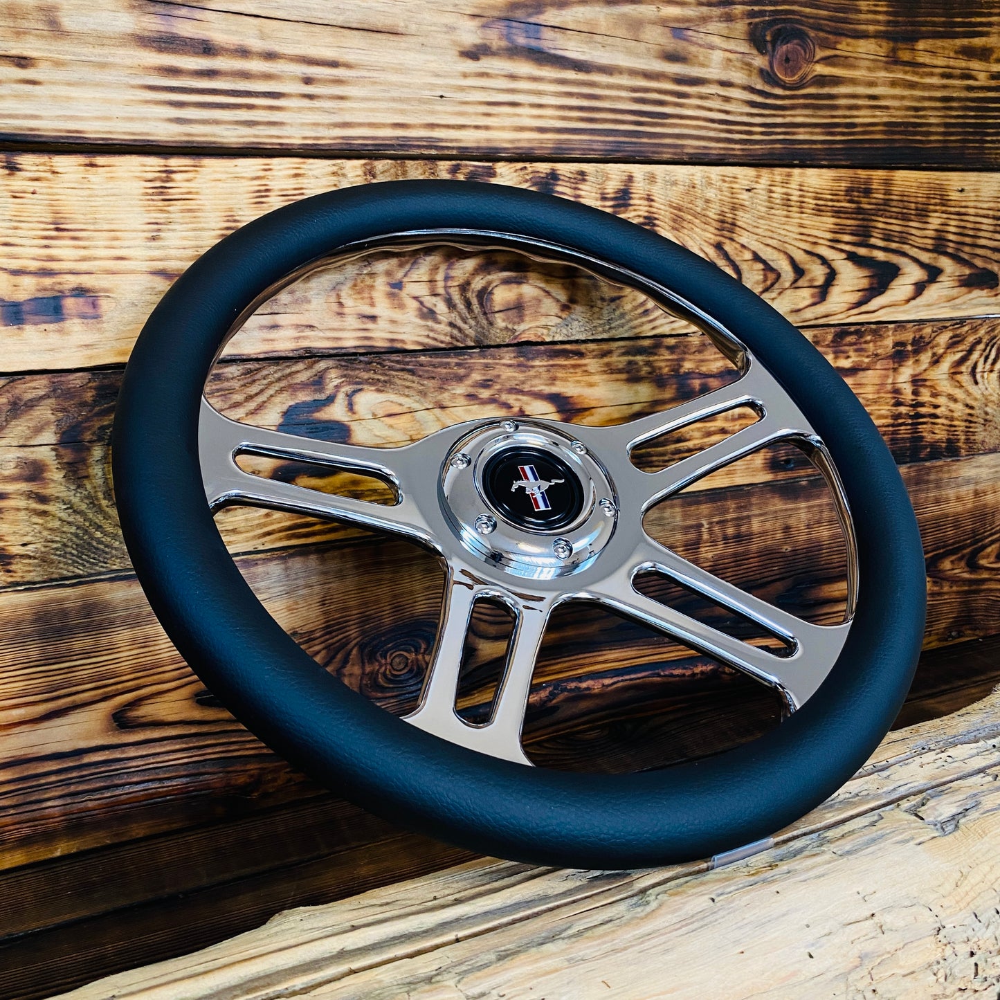 14 inch leather steering wheel with polished metal spokes and Mustang emblem front view aftermarket steering wheel for Mustang