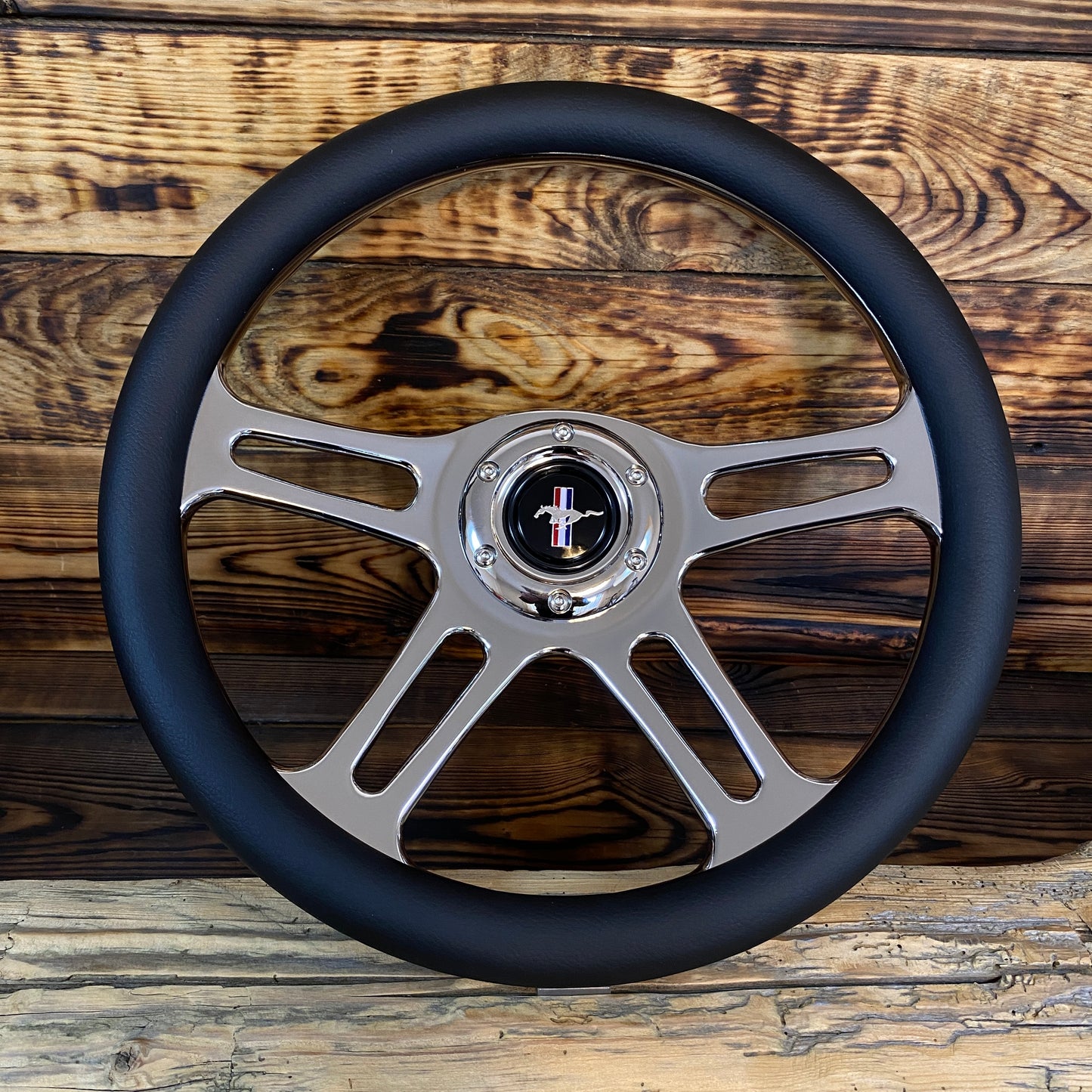 14in leather aftermarket steering wheel for Mustang with polished metal spokes and classic Mustang emblem front view