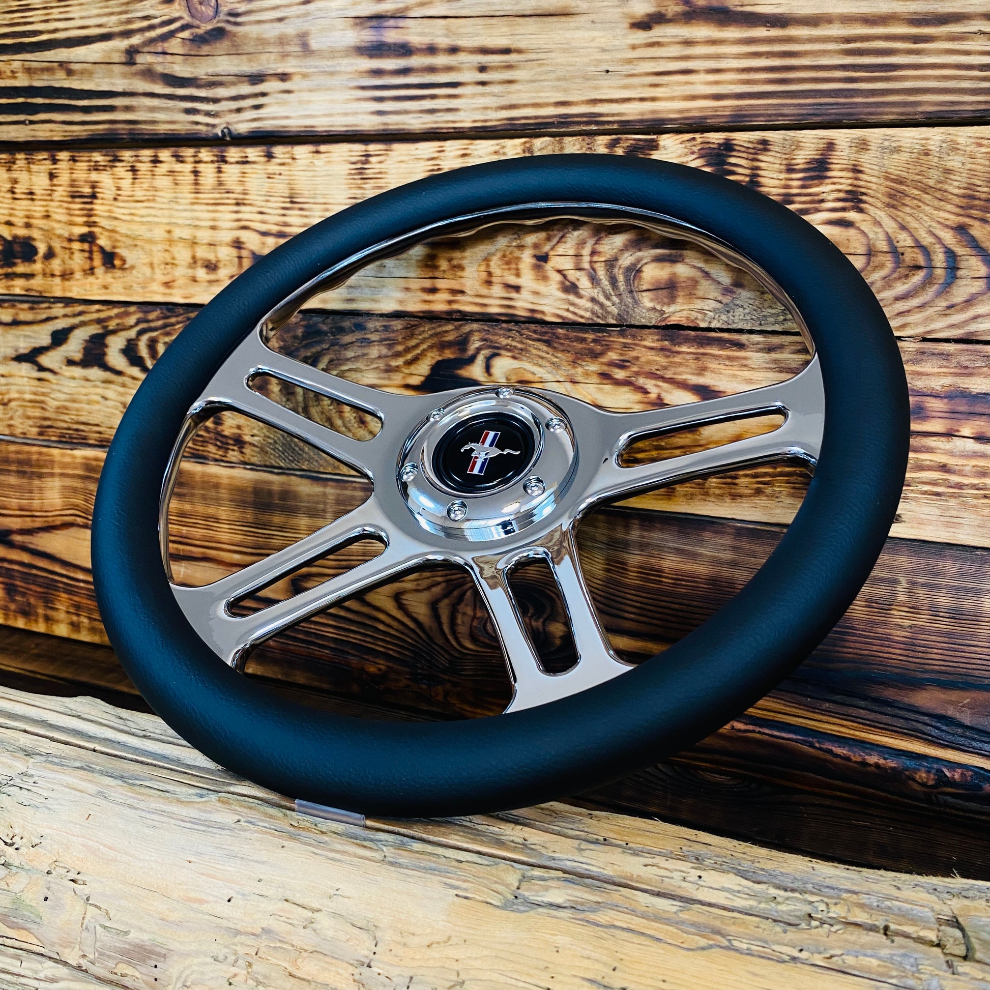 14 inch leather aftermarket steering wheel for Mustang with chrome spokes and Mustang emblem front view