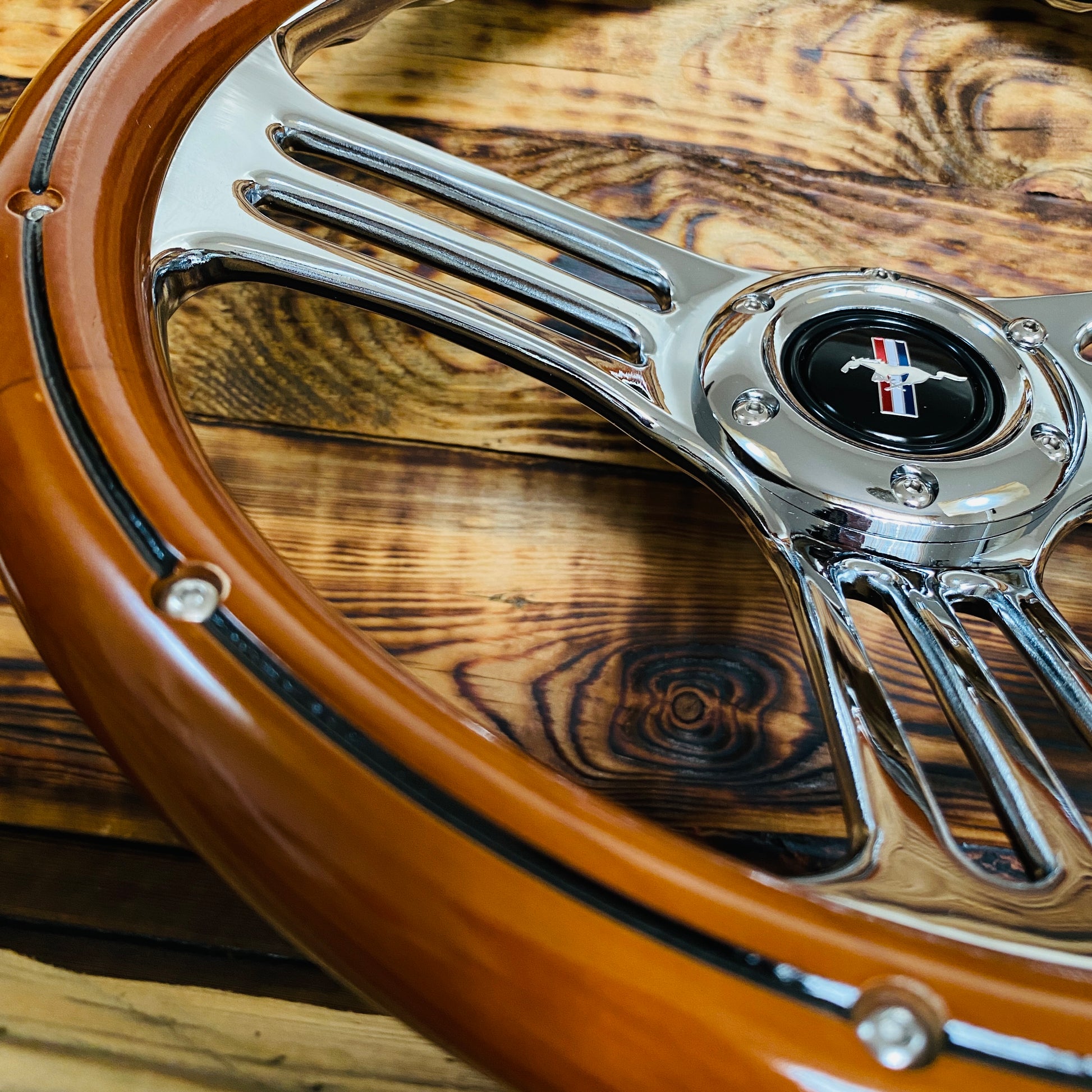 14 inch Mustang wood steering wheel with polished metal spokes and classic Mustang logo front view