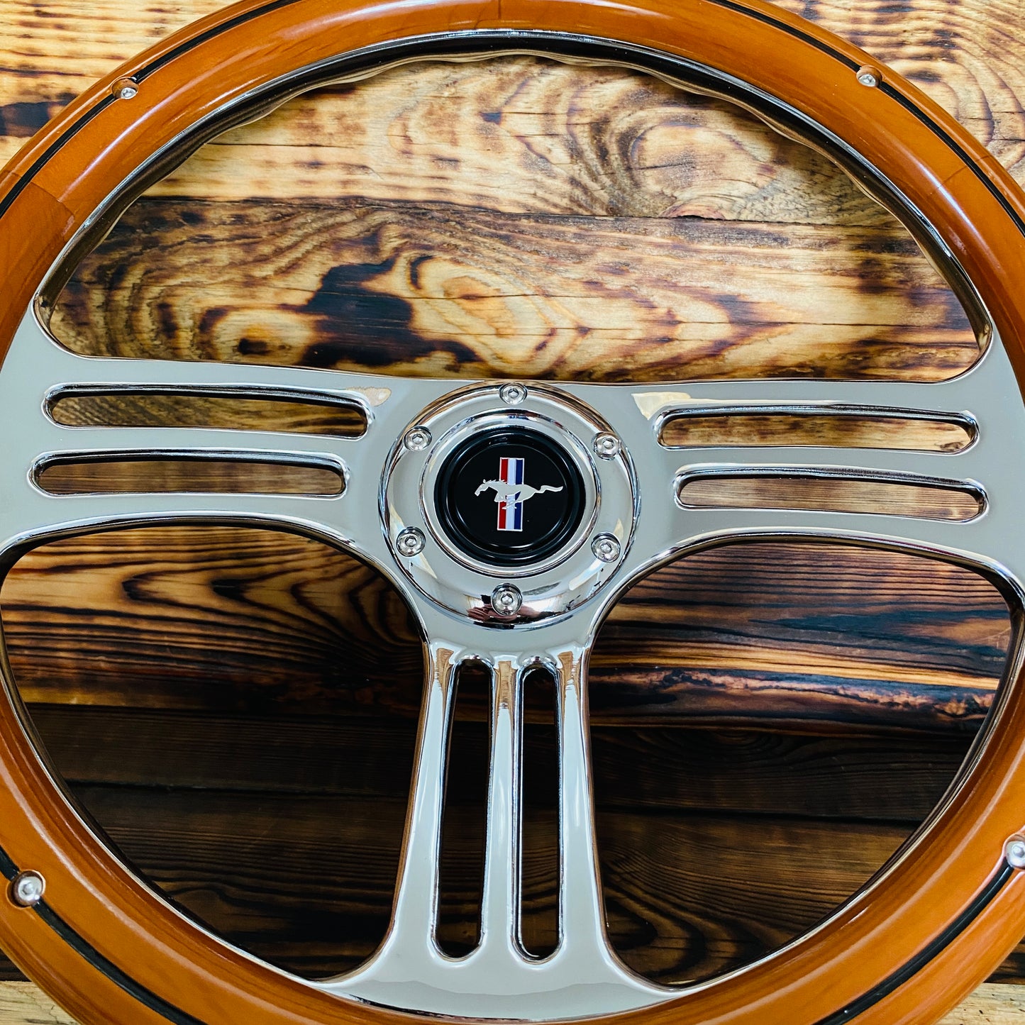 14 inch Mustang wood steering wheel with polished metal spokes and center emblem view