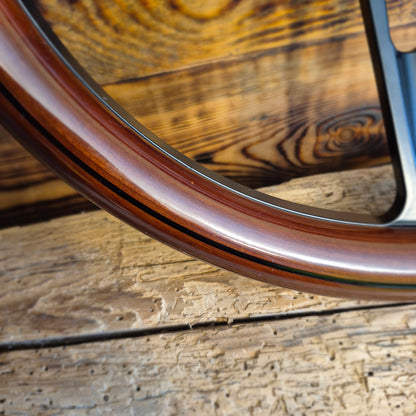 Close-up of 14 inch wood steering wheel rim with metal spokes showing polished finish for steering wheel for Ford Mustang