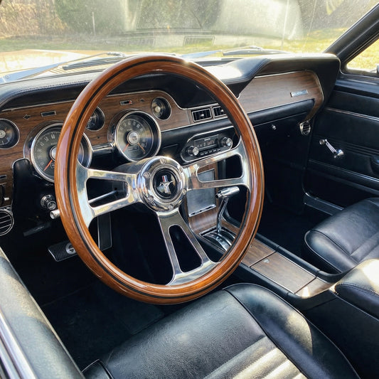 14 inch wood Mustang steering wheel with polished metal spokes installed in classic car interior