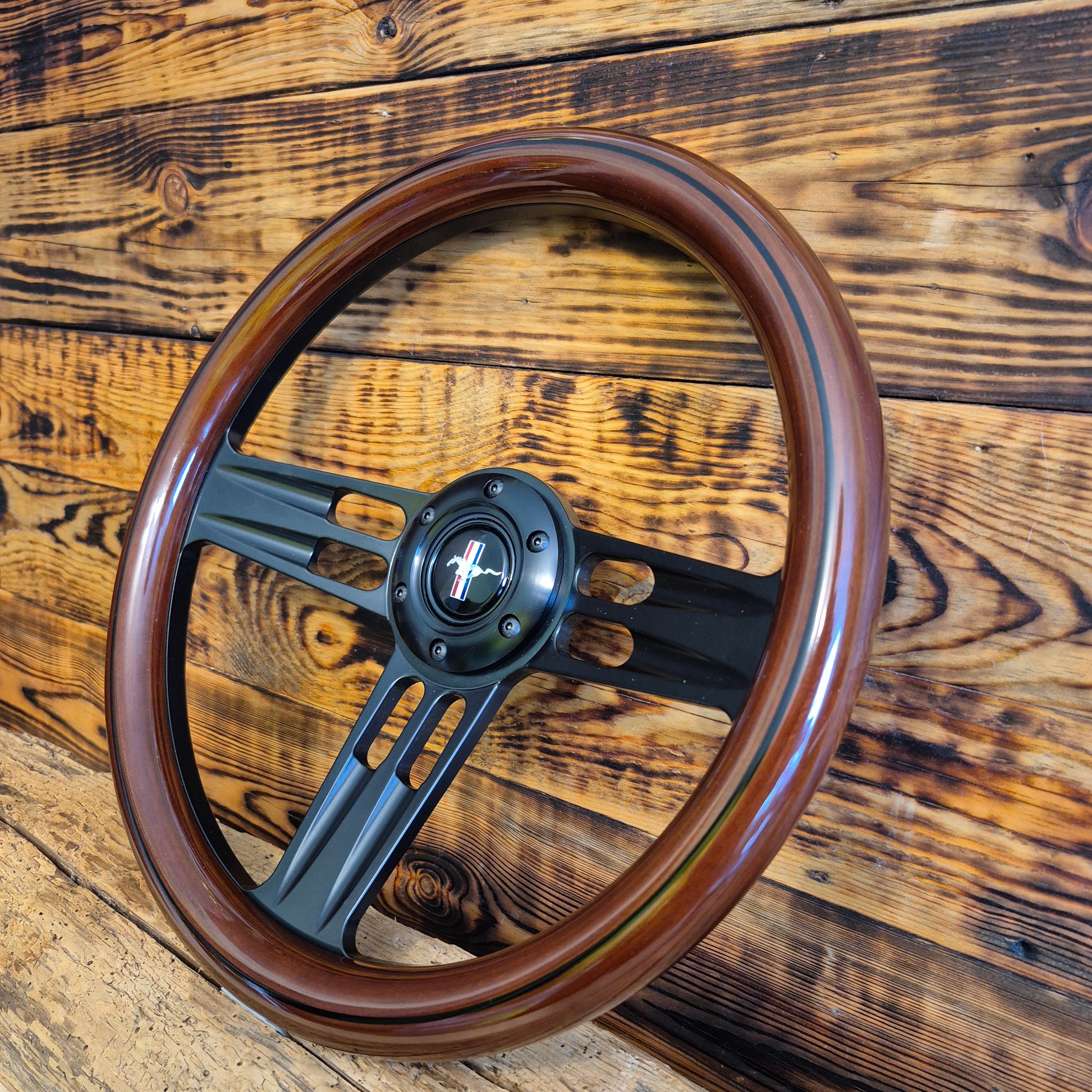 14in wood steering wheel for Ford Mustang with black metal spokes and Mustang logo center viewed front