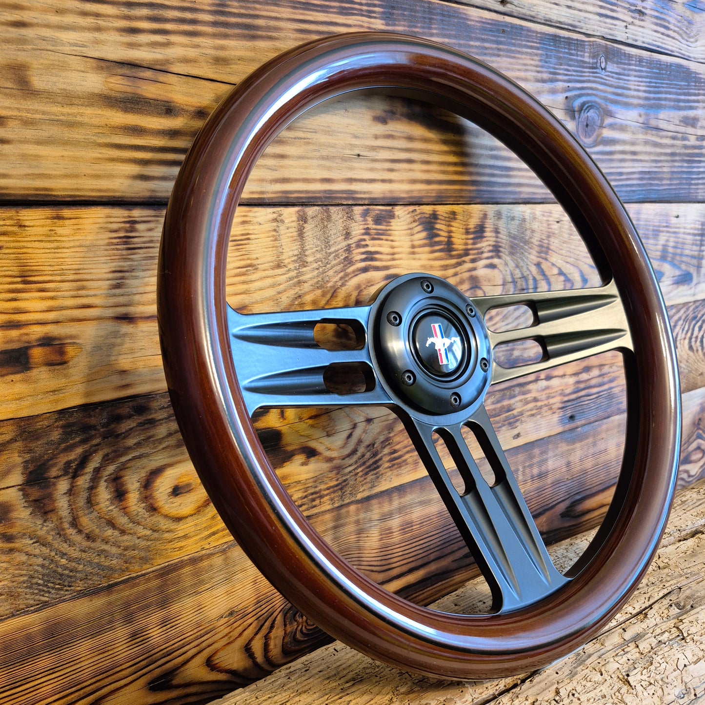 14 inch wood steering wheel for Ford Mustang with metal spokes, center emblem, angled side view