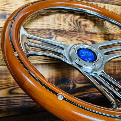 14in Ford wood steering wheel with chrome spokes and blue Ford center cap close-up view