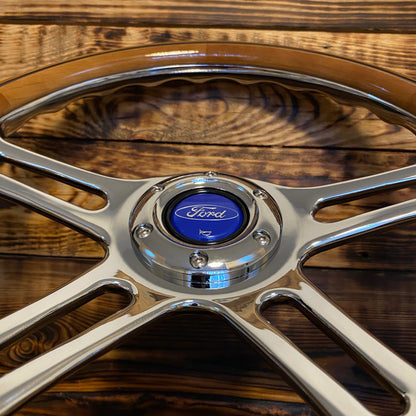 14 inch wood steering wheel for Ford with polished metal spokes and blue Ford center emblem shown on wooden background