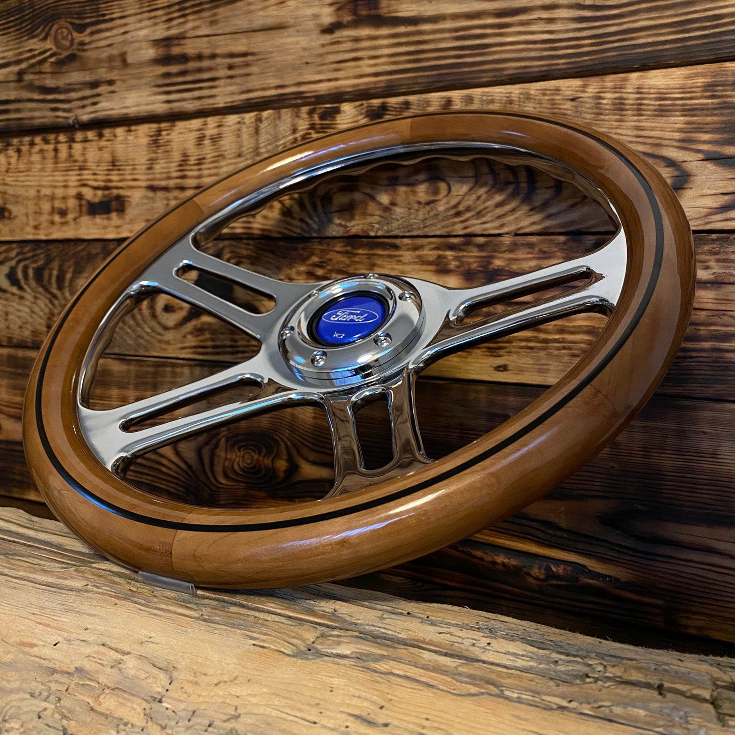 14 inch wood steering wheel for Ford with polished metal spokes and blue Ford center emblem angled view