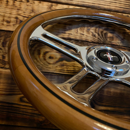 14in wooden steering wheel for Mustang with polished metal spokes and center emblem close-up view