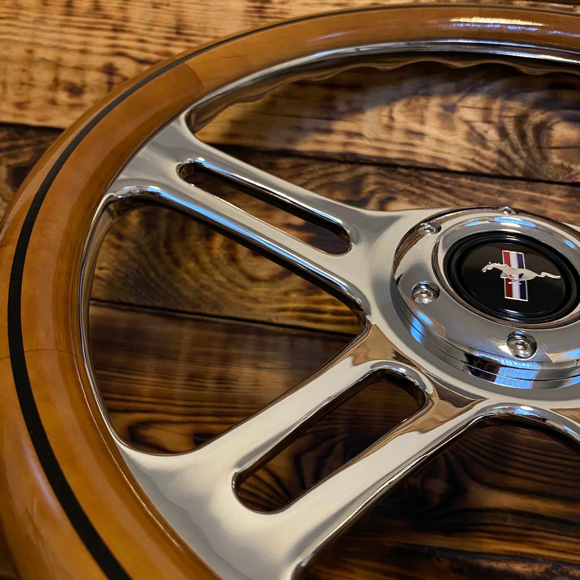 14 inch wooden steering wheel for Mustang with polished metal spokes and Ford Mustang emblem front view