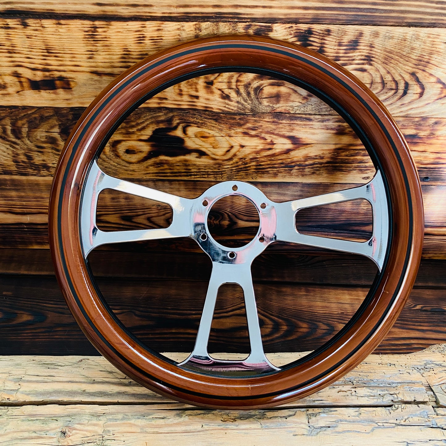 14in Ford wooden steering wheel with polished metal spokes by Punk Wheels front view on wooden background