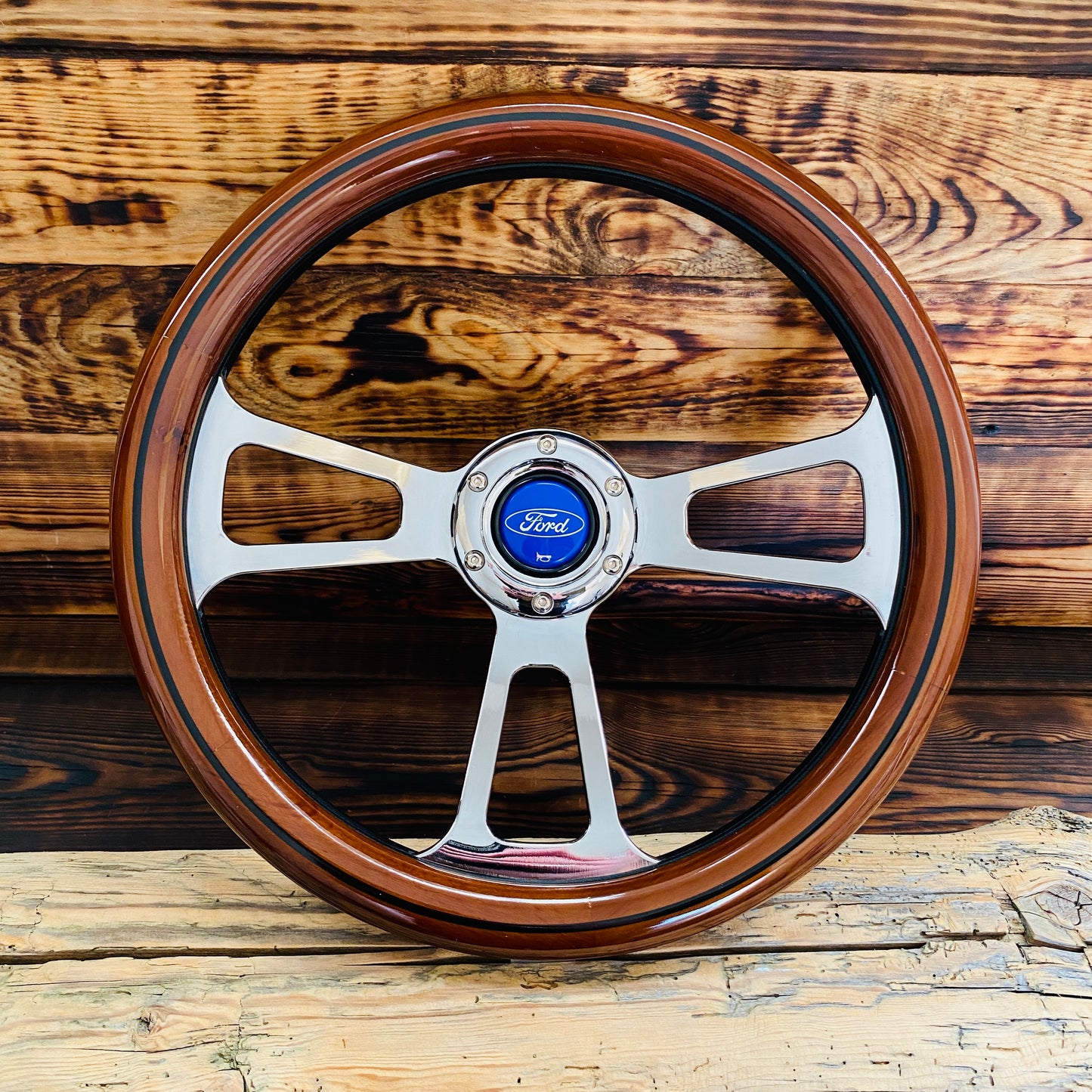 14 inch Ford wooden steering wheel with polished metal spokes and wood rim front view