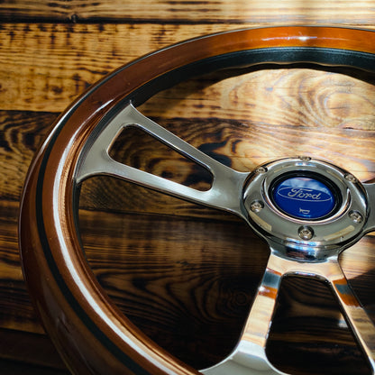 14in Ford wooden steering wheel with polished metal spokes and Ford emblem center close-up view