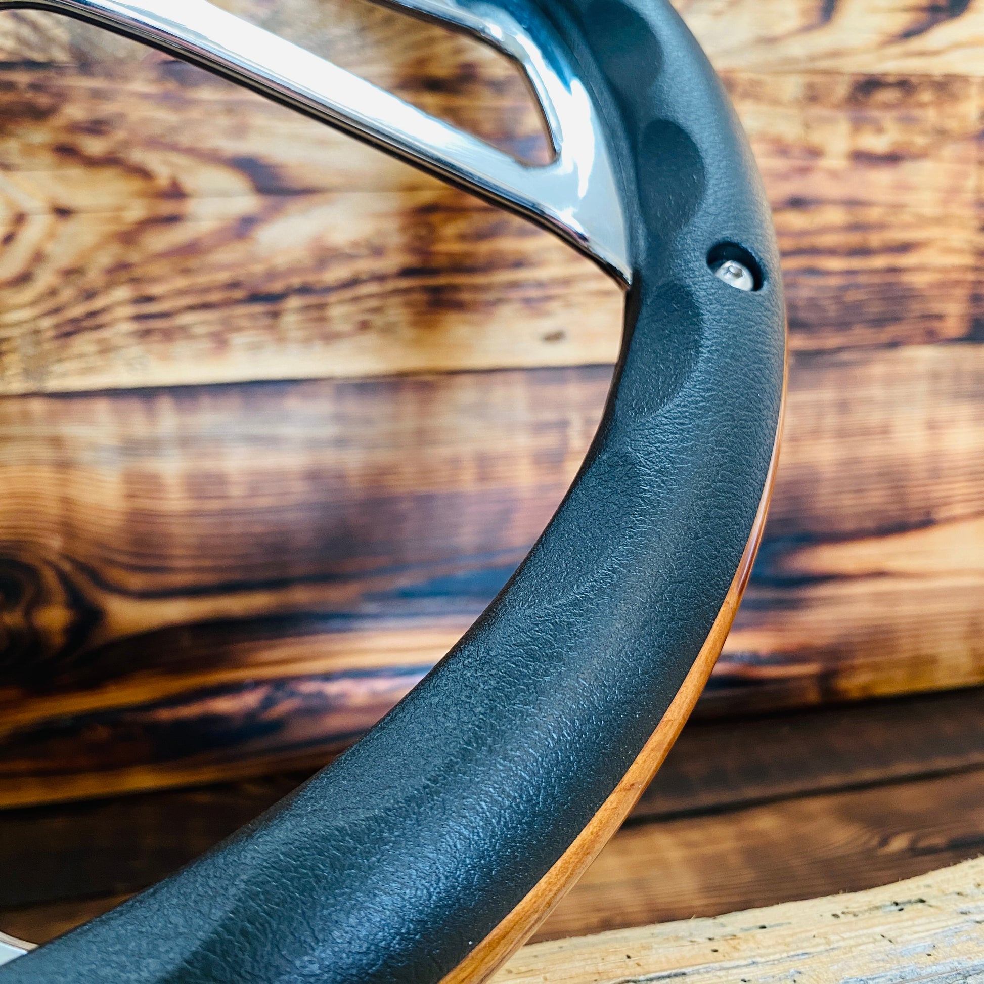 14in Ford wooden steering wheel with black leather grip and chrome spokes close-up view