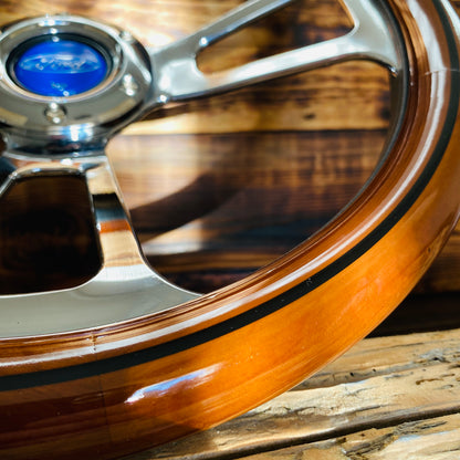 14in Ford wooden steering wheel with polished metal spokes and blue center cap close-up view