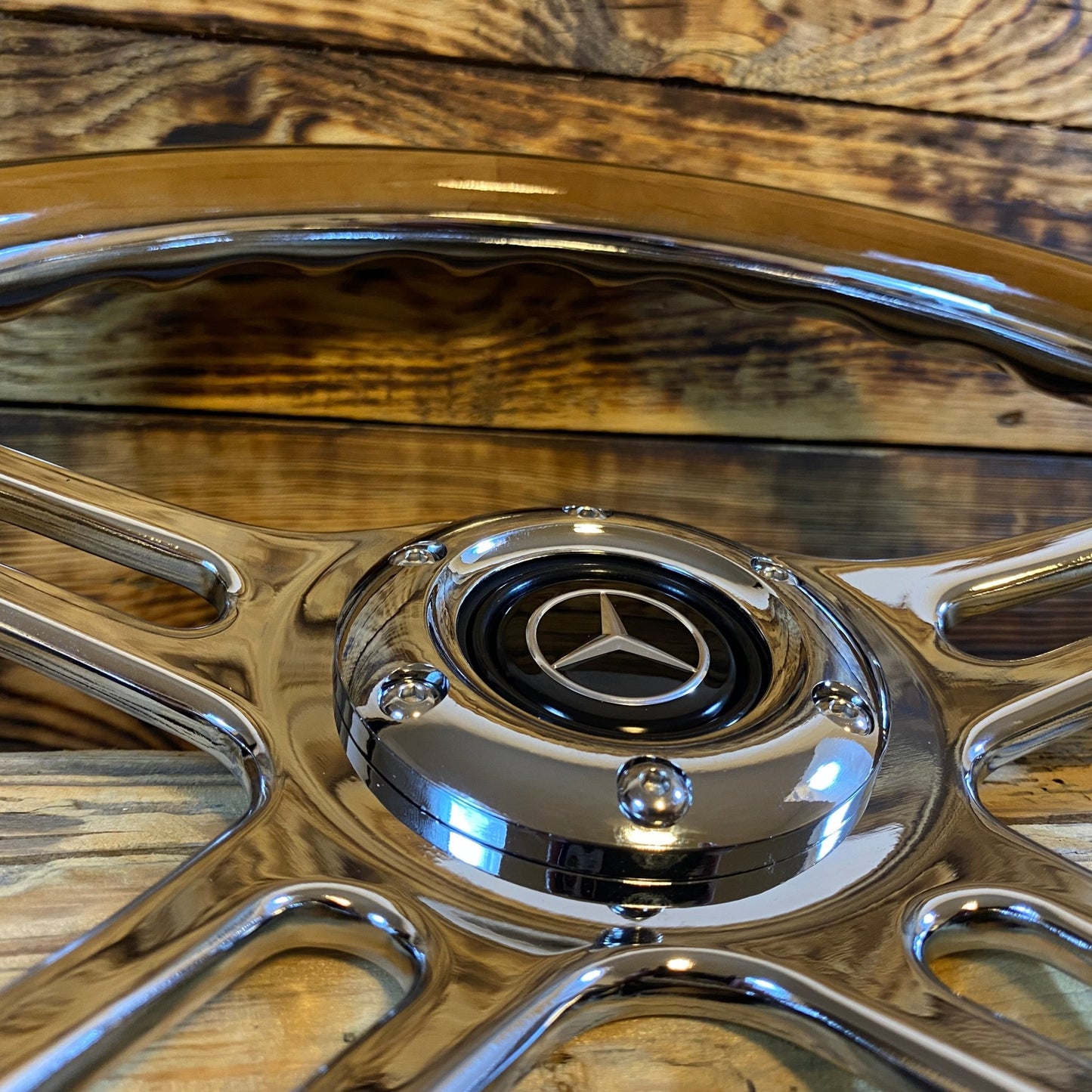14in wood steering wheel for Mercedes with chrome spokes and center emblem close-up view