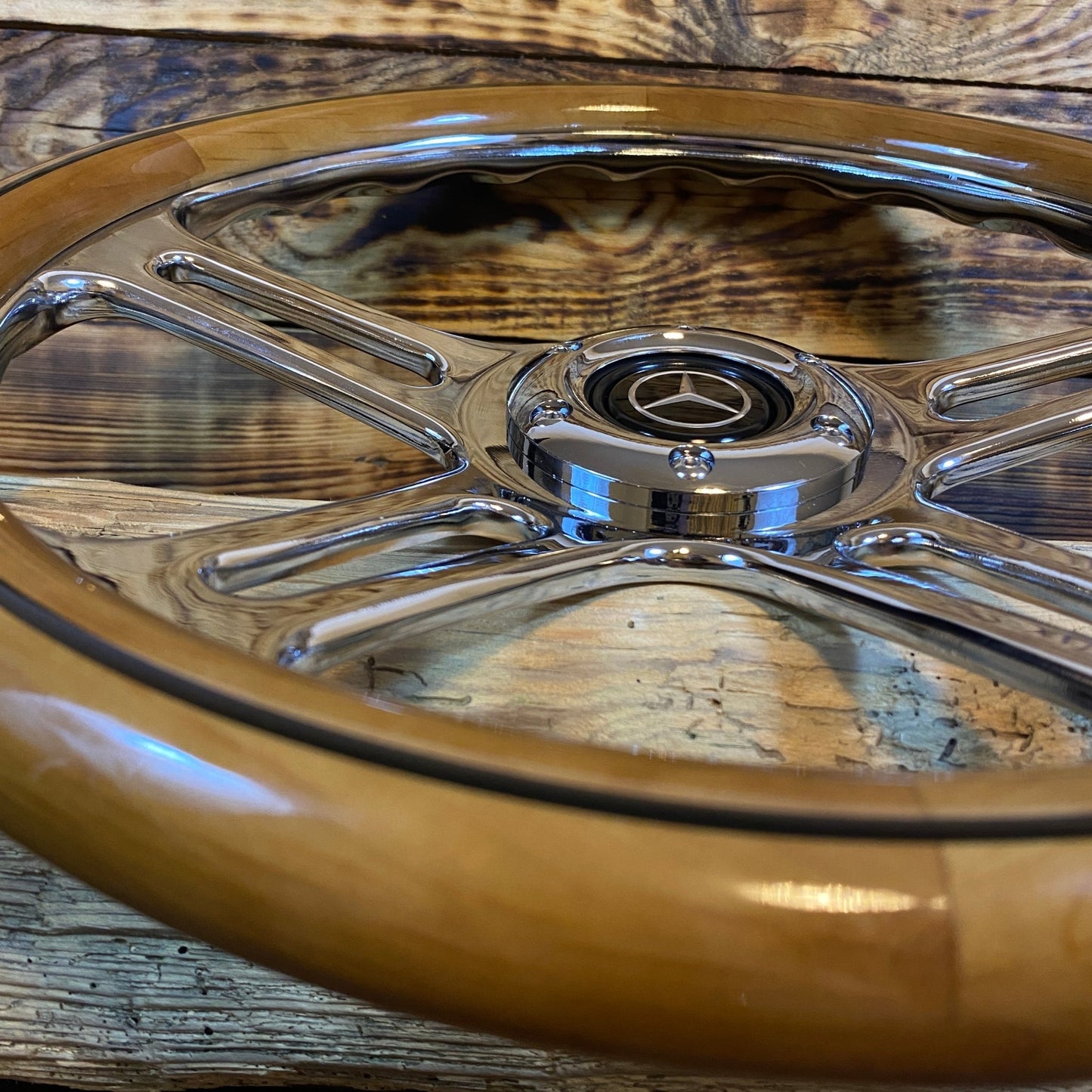 14-inch wood steering wheel for Mercedes with chrome spokes and center emblem close-up view