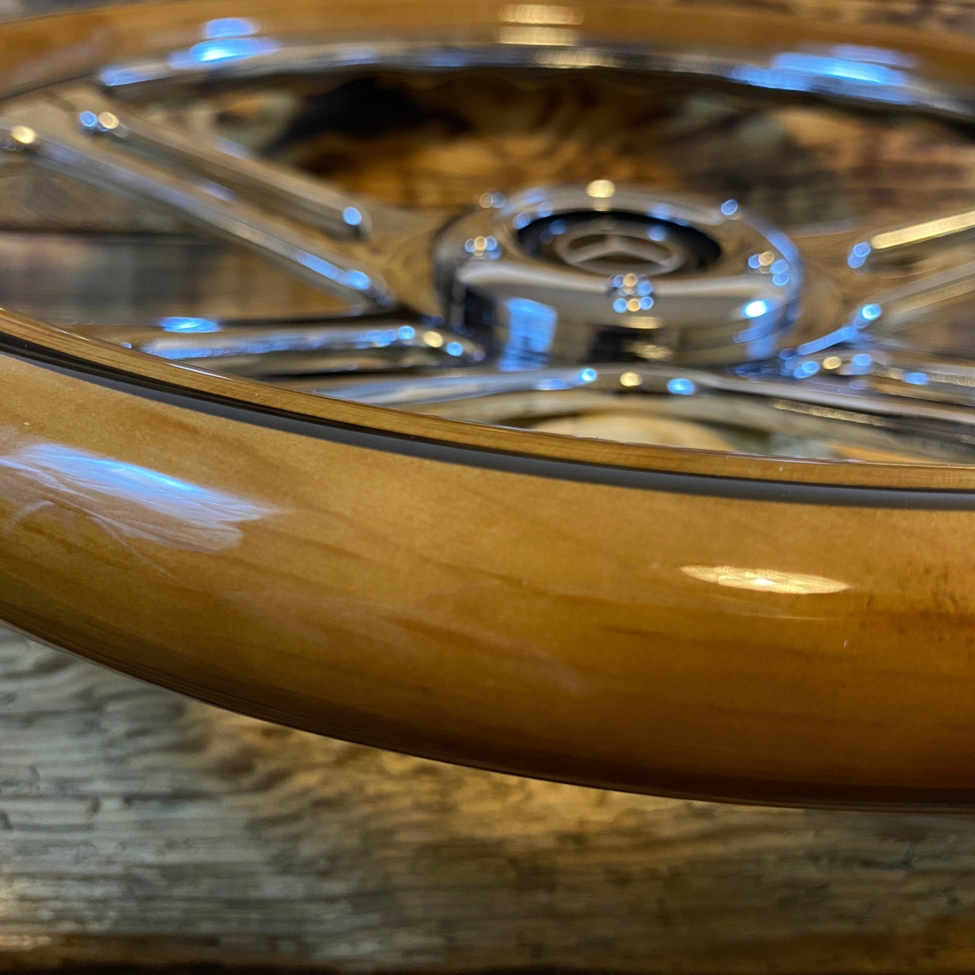 Close-up view of 14-inch wood steering wheel for Mercedes by Punk Wheels with polished chrome spokes