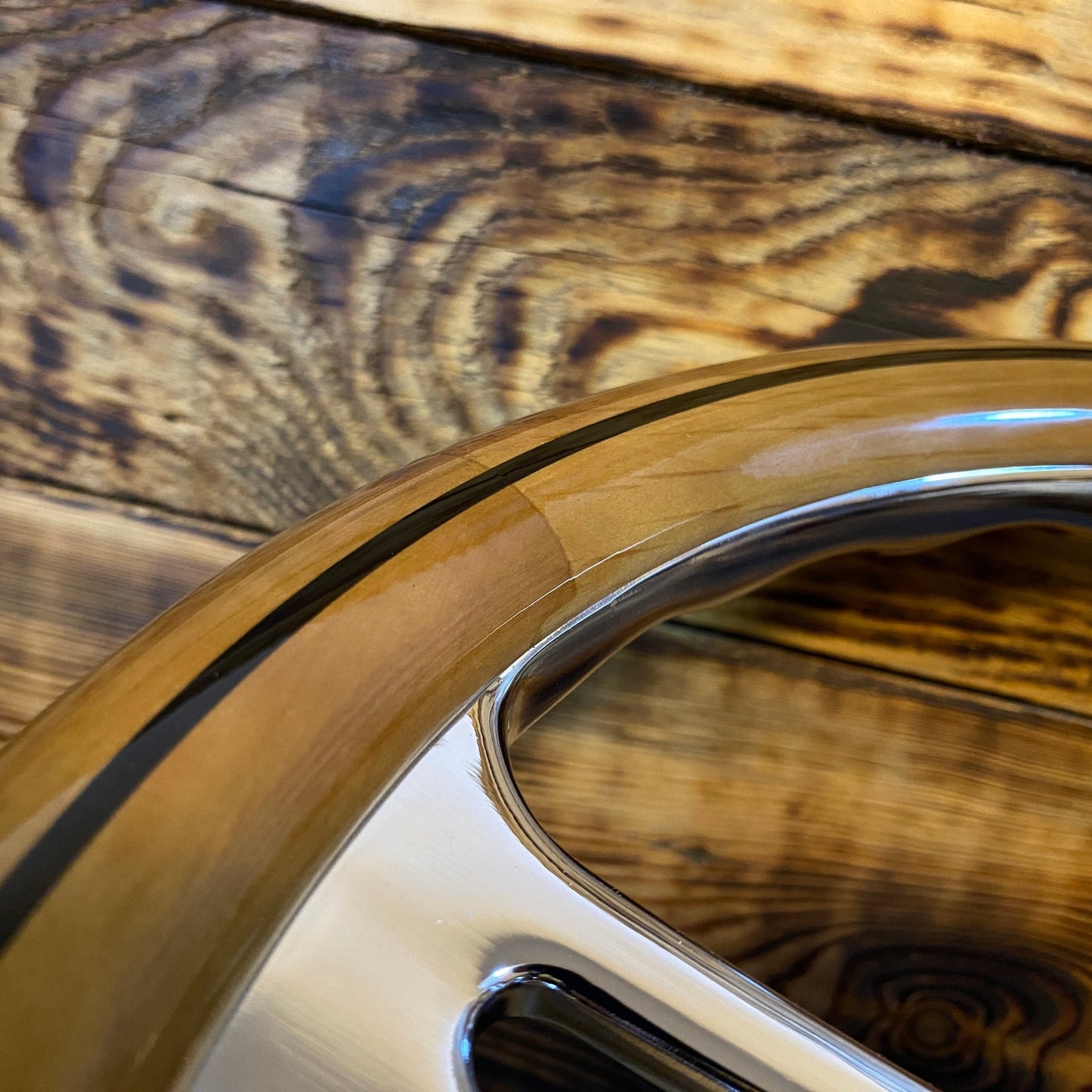 Close-up of 14 inch wood steering wheel for Mercedes with polished metal spokes by Punk Wheels