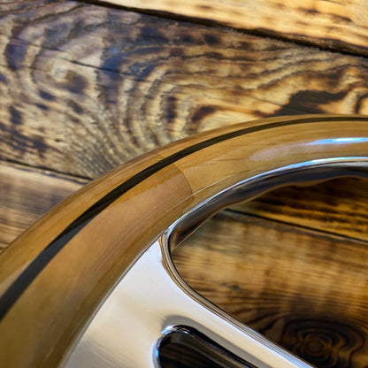 Close-up of 14 inch wood steering wheel for Mercedes with polished metal spokes by Punk Wheels