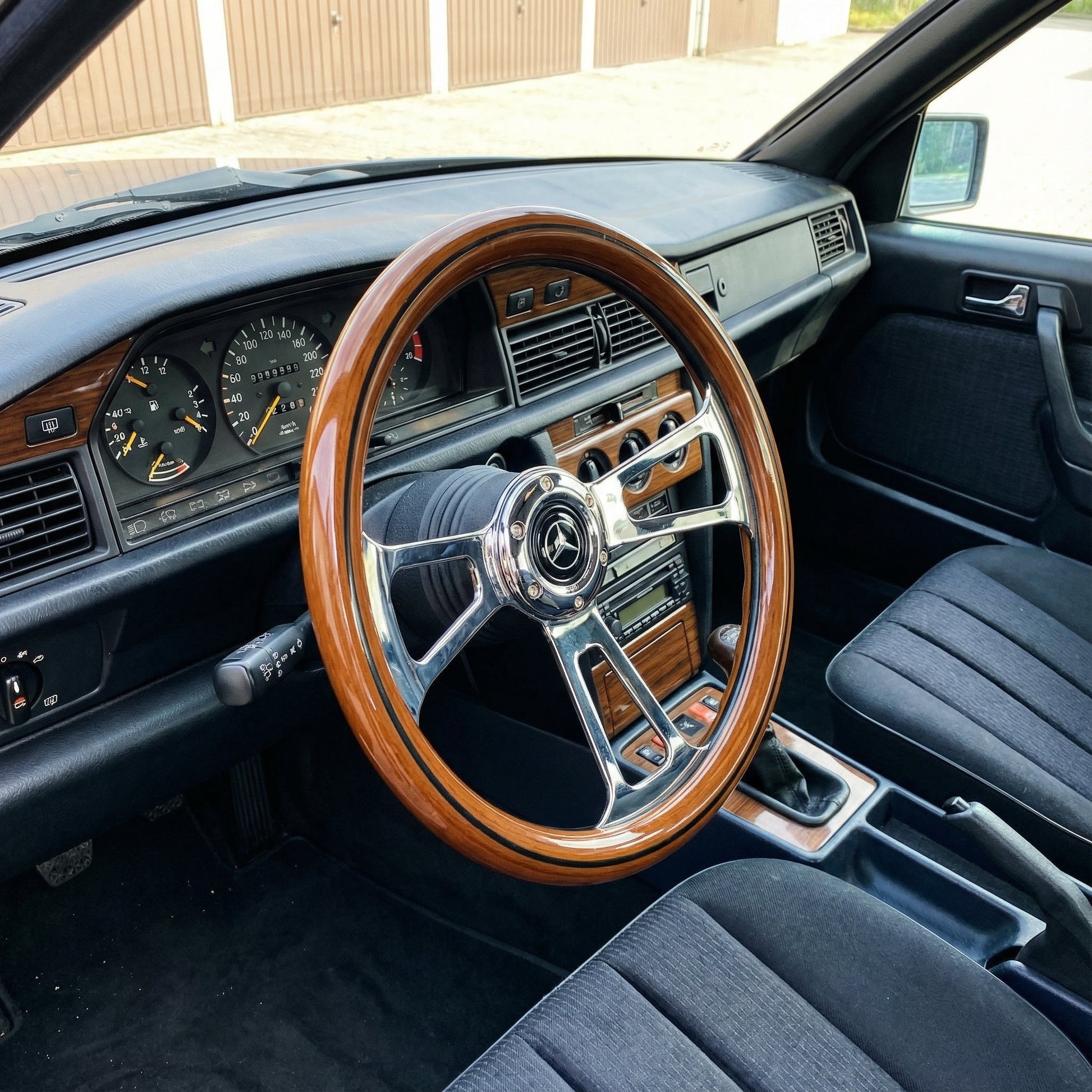14in Mercedes wood steering wheel with chrome spokes installed in classic car interior view