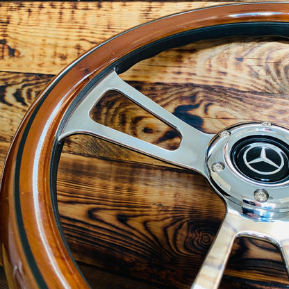 Close-up of 14in Mercedes wood steering wheel by Punk Wheels with polished metal spokes and black grip