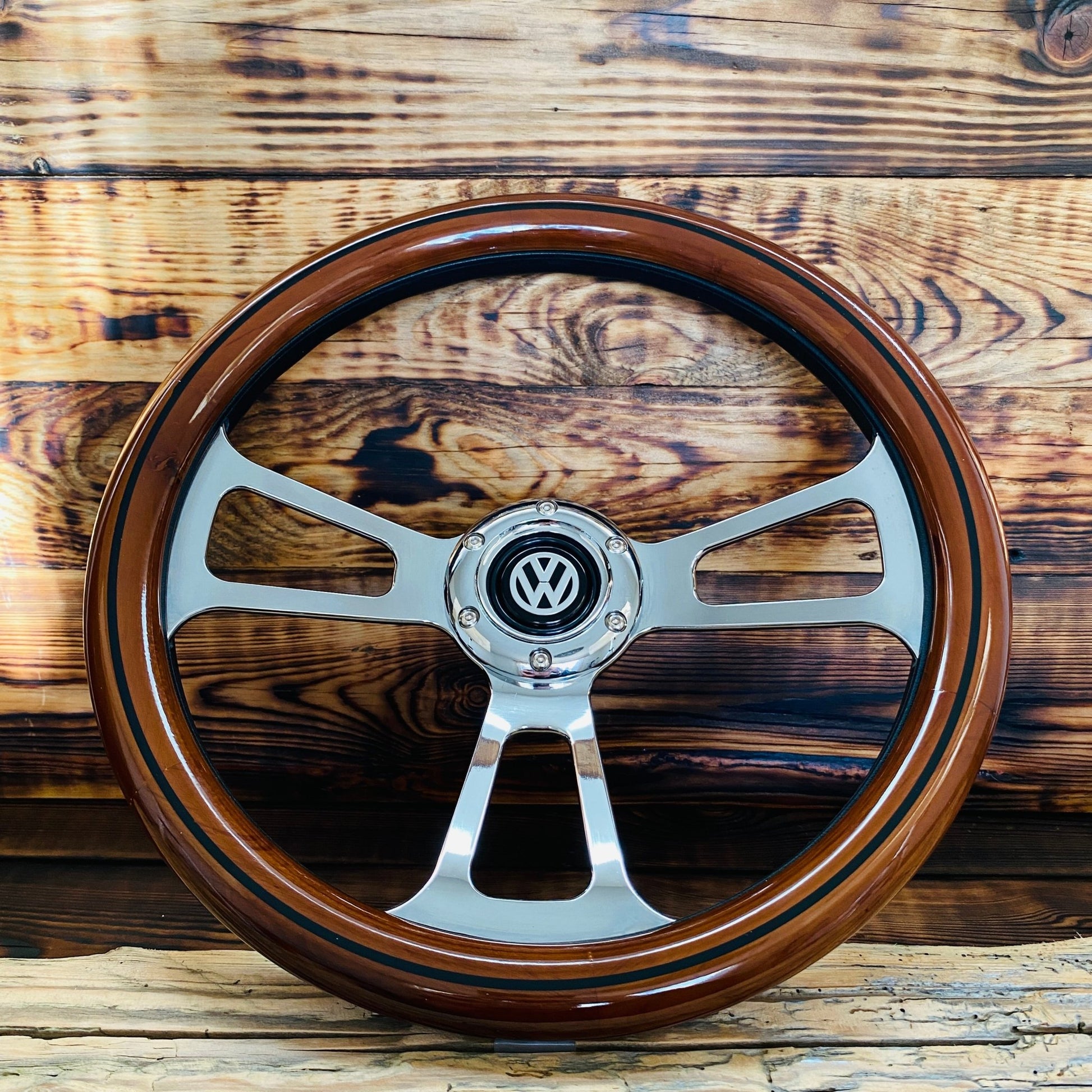 14 inch wood steering wheel for VW with polished metal spokes and center emblem front view
