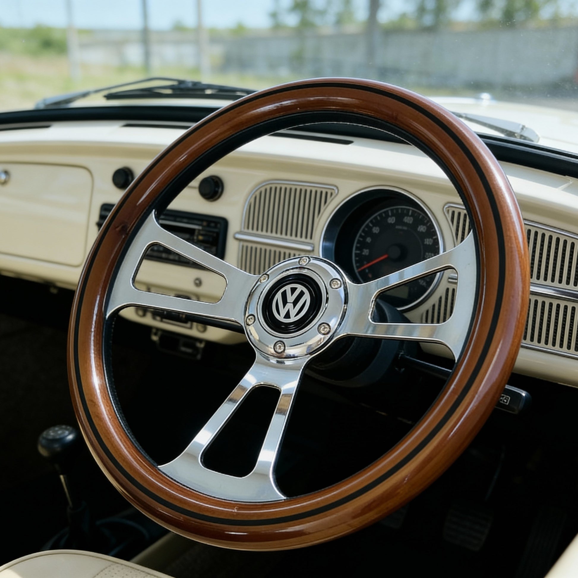 14 inch wood steering wheel for VW with polished metal spokes and VW emblem front view installed in vintage car